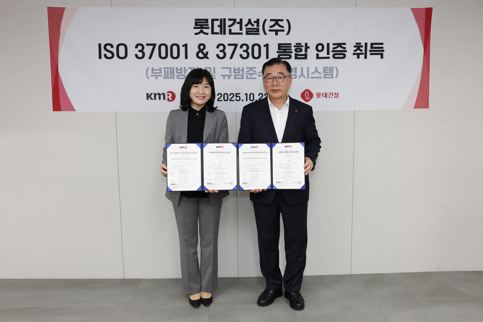 롯데건설 박현철 부회장(오른쪽)과 한국경영인증원 황은주 대표이사(왼쪽)가 ISO 통합인증 수여식에서 기념촬영을 하고 있다. [사진=롯데건설]