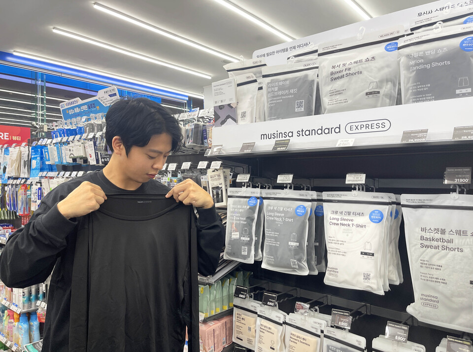고객이 GS25에서 무신사 스탠다드의 힛탠다드 이너웨어 상품을 살펴보고 있다. [사진=GS리테일]
